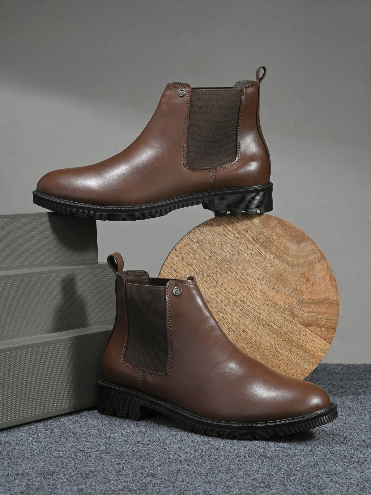 Black leather Classic Chelsea boot with elastic side panels, pull-tab at the heel, rounded toe, and a small metallic brand logo near the ankle.