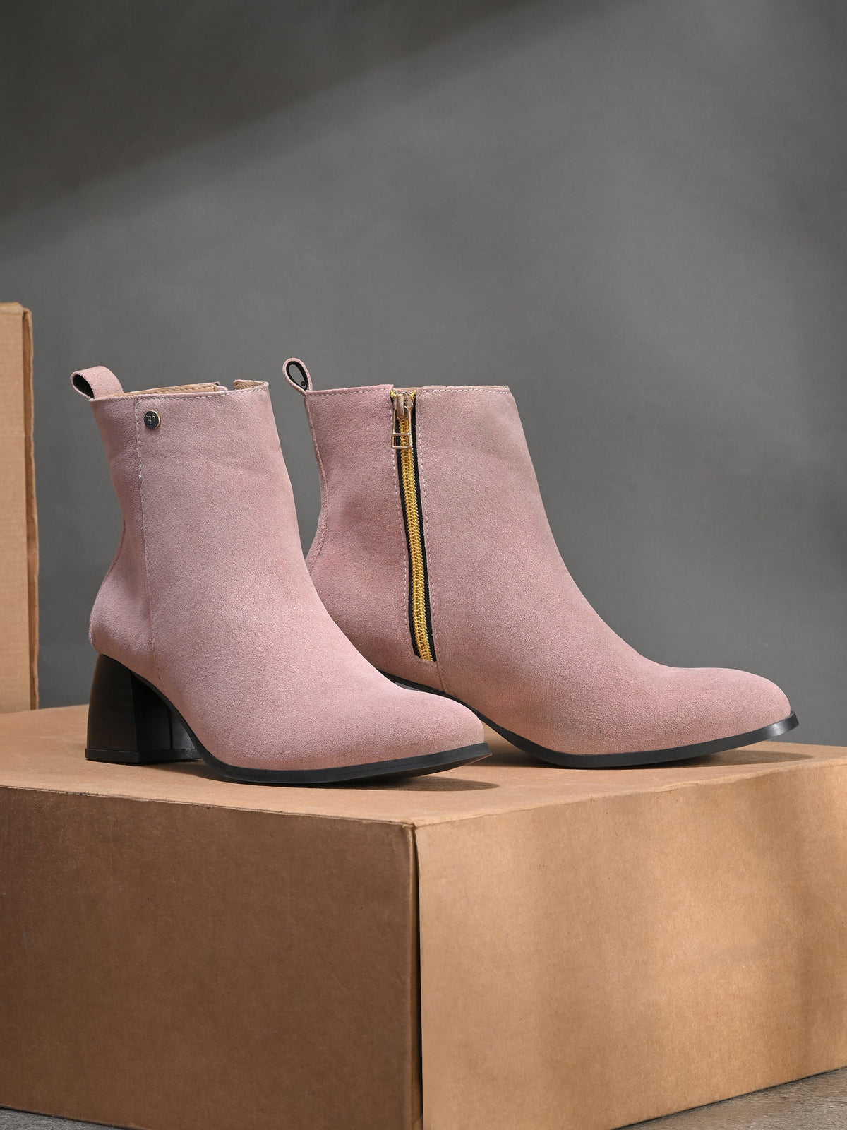 Light pink Suede ankle boots for women with a block heel and a sleek, minimalist design.