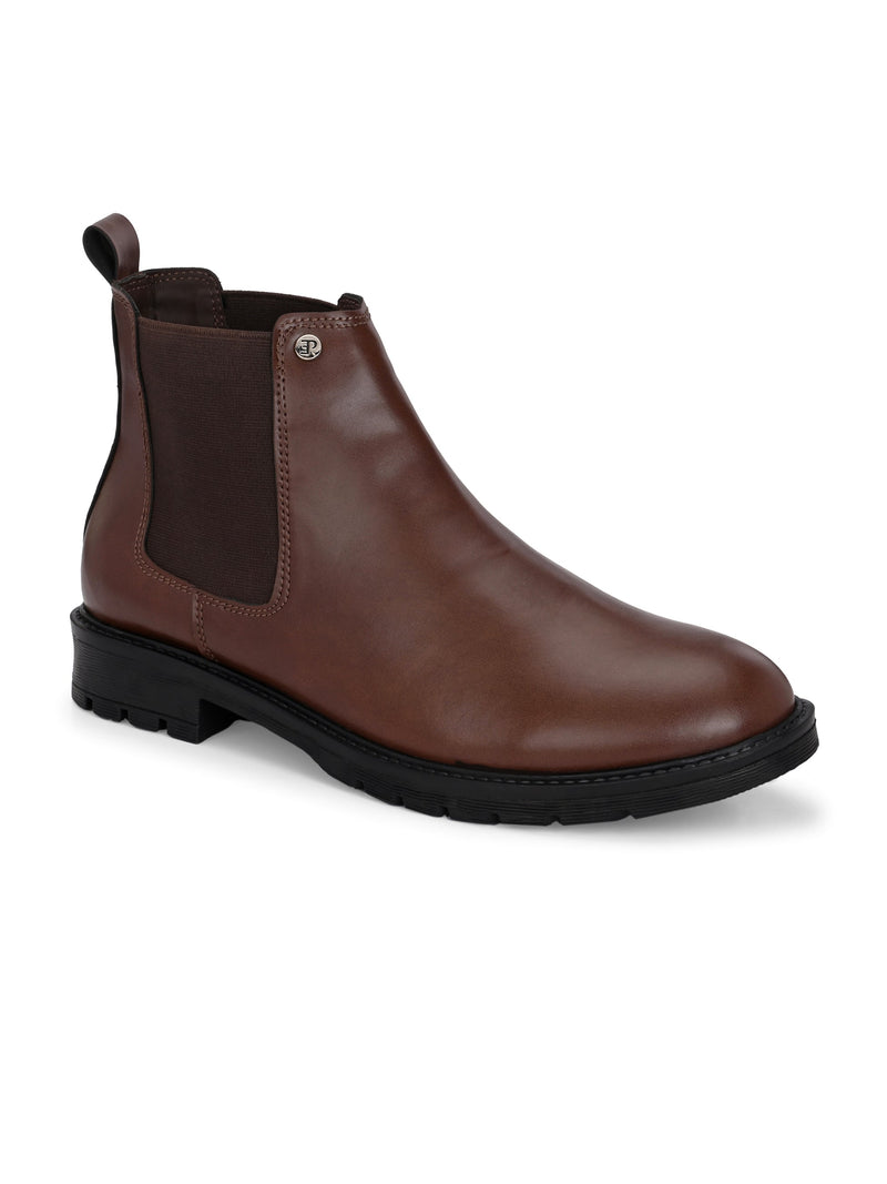 Brown Chelsea boots with elastic side panels, a pull-tab at the heel, rounded toe, and a small metallic brand logo near the ankle.