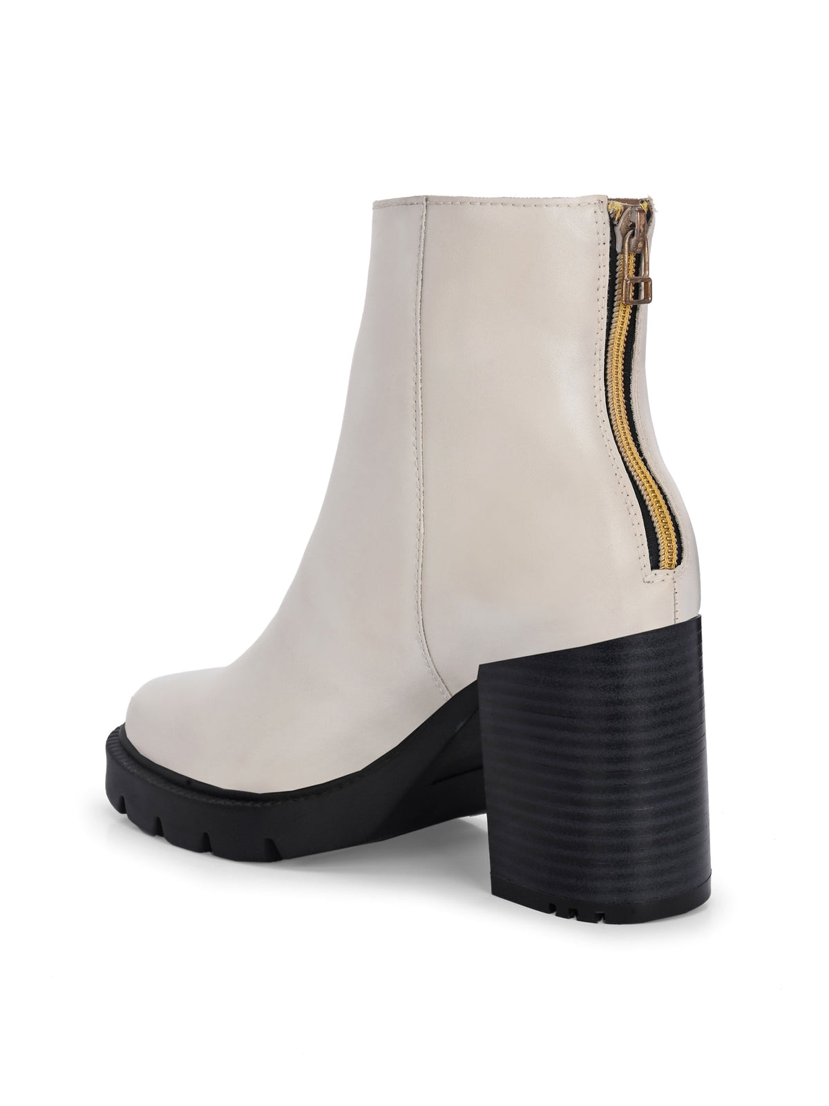 Glossy beige patent leather ankle boot with a chunky block heel, lug sole, and a gold logo detail near the collar.