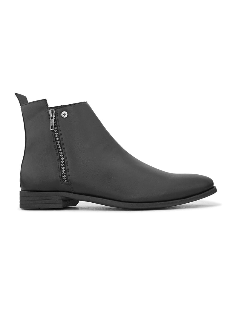 A sleek black leather Chelsea boot with a side zipper, pull-tab at the back, and a low block heel.