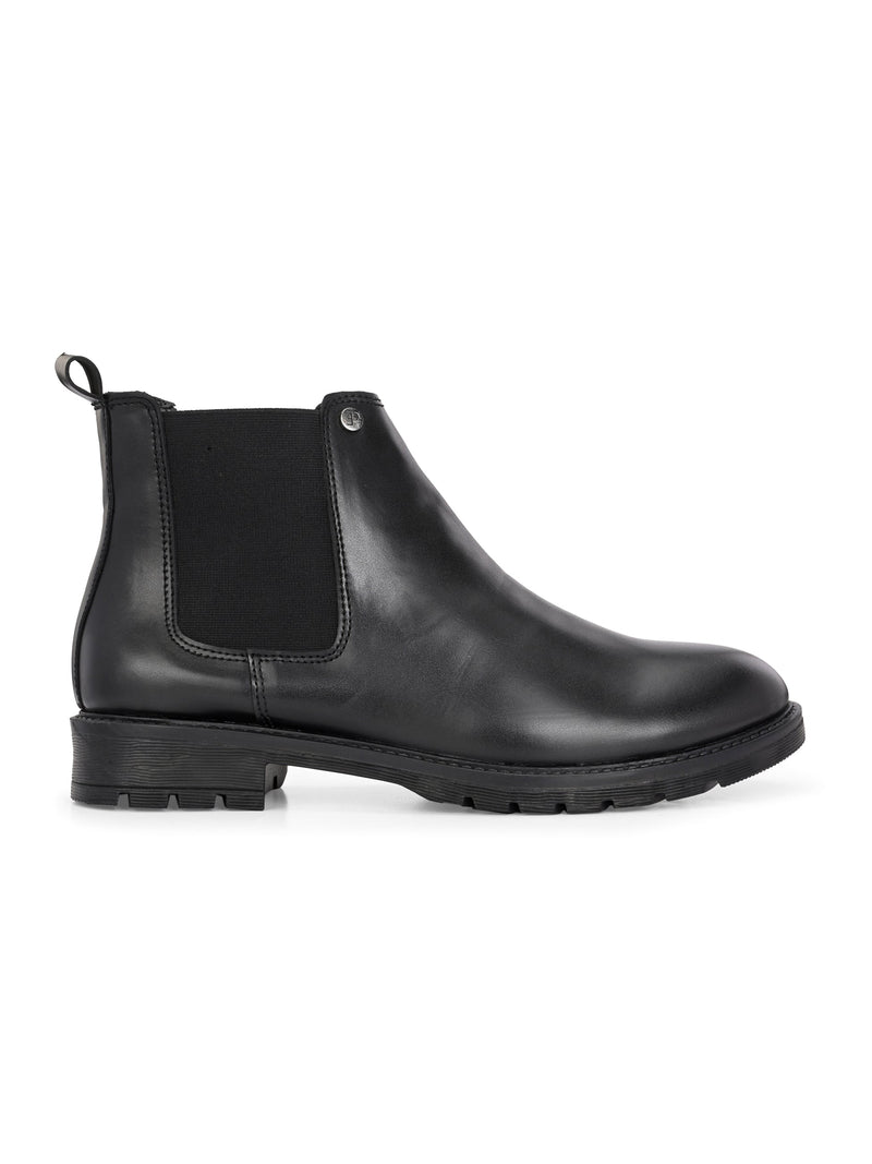 Classic Chelsea boots with elastic side panels, a pull-tab at the heel, rounded toe, and a small metallic brand logo near the ankle.
