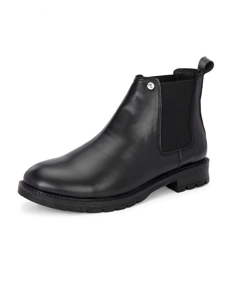 Classic Chelsea boots with elastic side panels, a pull-tab at the heel, rounded toe, and a small metallic brand logo near the ankle.