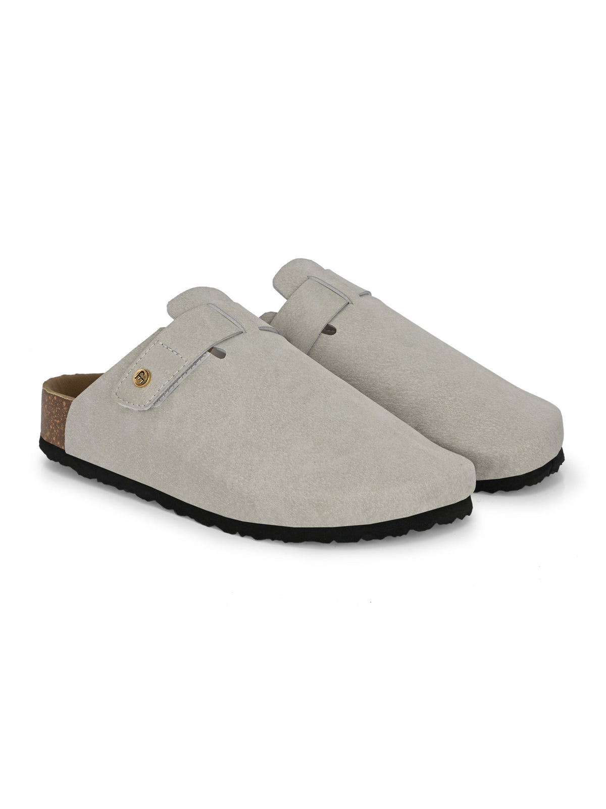 Nude suede slip-on clog with a black rubber sole and adjustable strap.
