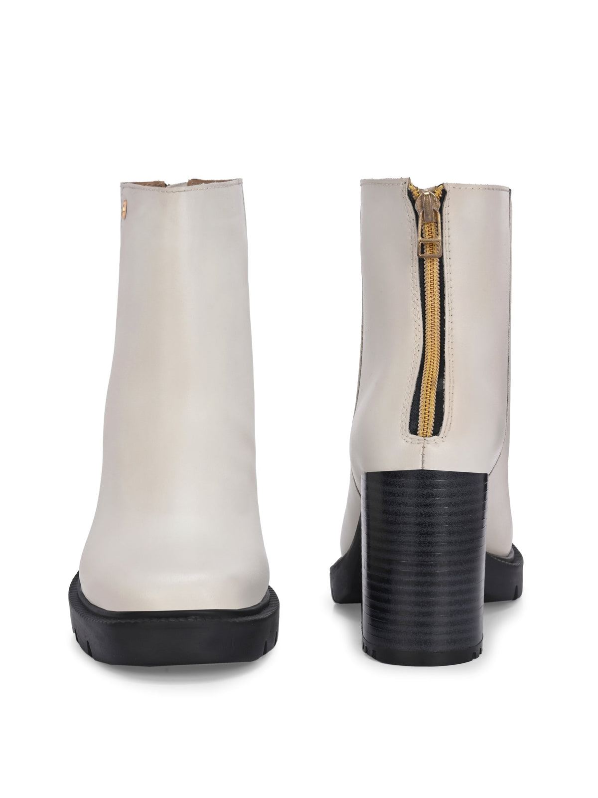 Glossy beige patent leather ankle boot with a chunky block heel, lug sole, and a gold logo detail near the collar.