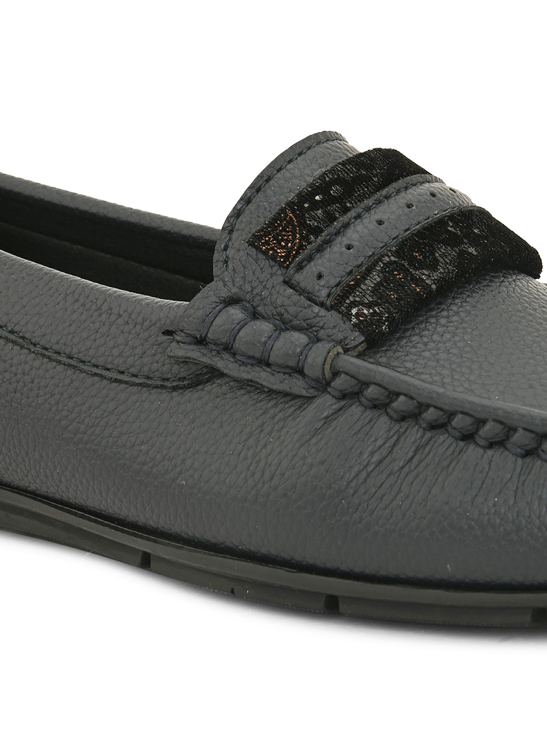 A single dark gray leather loafer with a textured sole and decorative strap across the front.